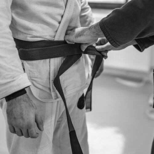 Jiu-Jitsu Instructor Tying Students belt