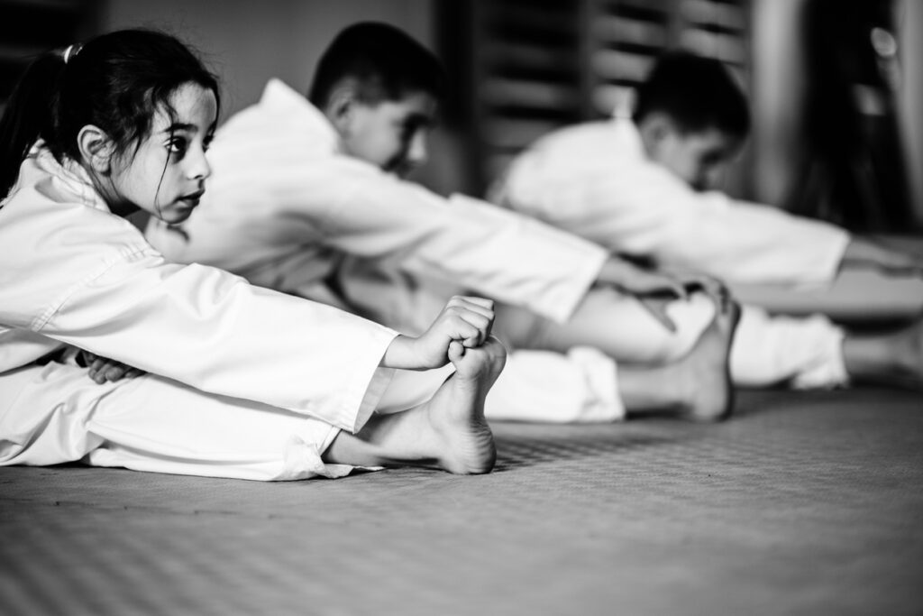 Kids Jiu-Jitsu class, students stretching